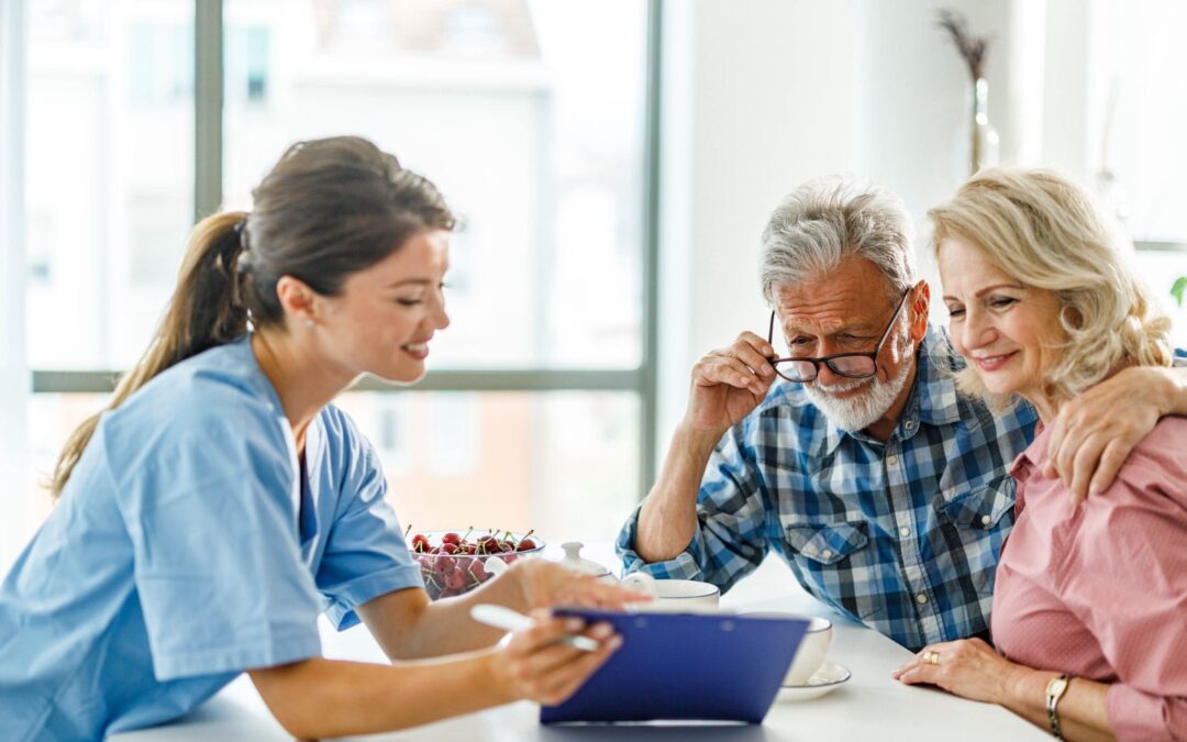 Insurance agent reviewing paperwork with senior couple